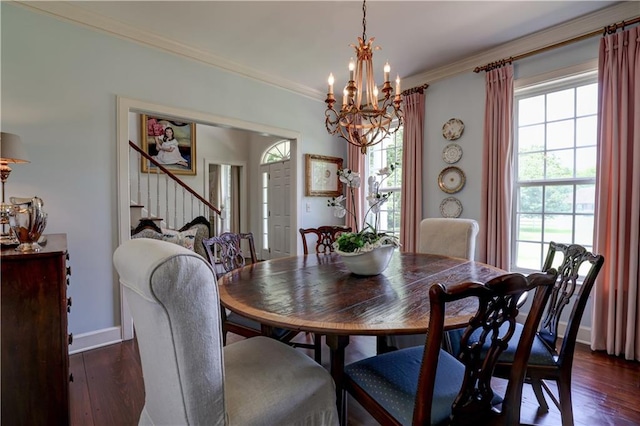 dining space with dark hardwood / wood-style floors, plenty of natural light, and a notable chandelier