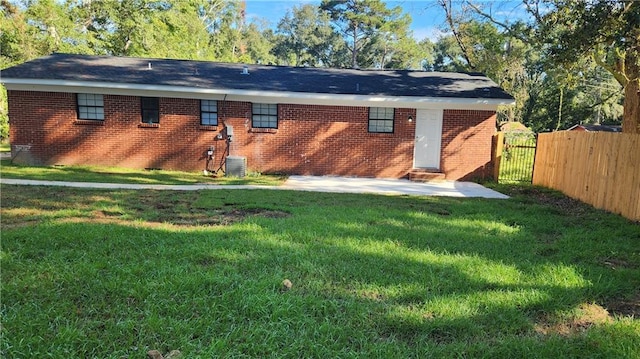 rear view of house with a yard