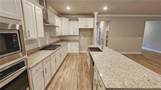 kitchen with light stone counters, sink, and stainless steel appliances