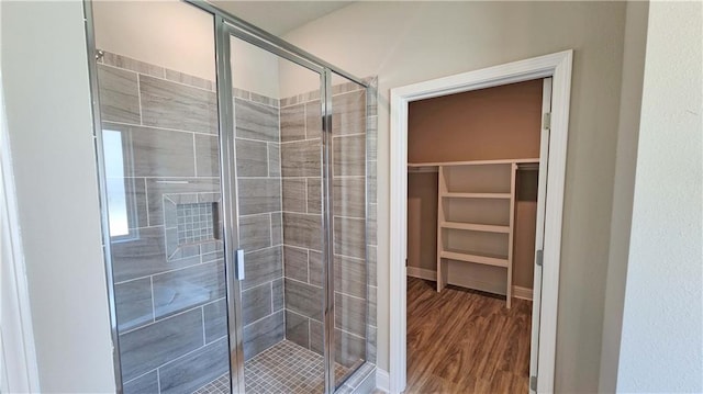 bathroom featuring an enclosed shower and wood-type flooring