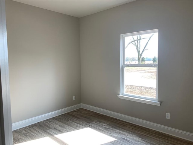 spare room featuring hardwood / wood-style floors and a healthy amount of sunlight