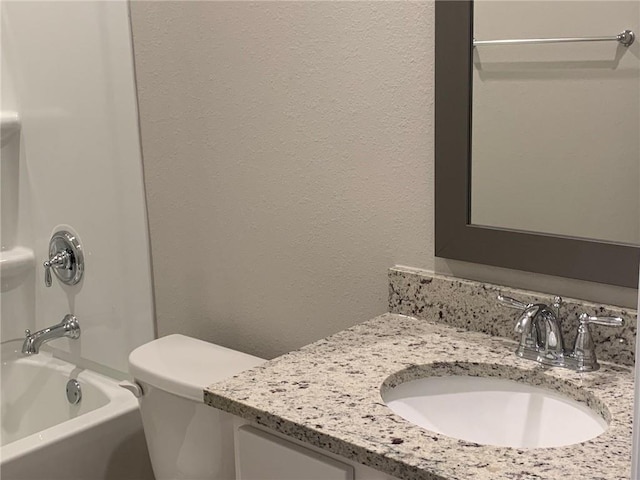 full bathroom featuring vanity, shower / bath combination, and toilet