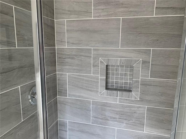 room details featuring a shower with door