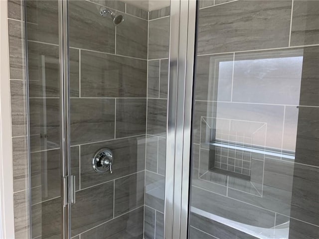 bathroom with a shower with door