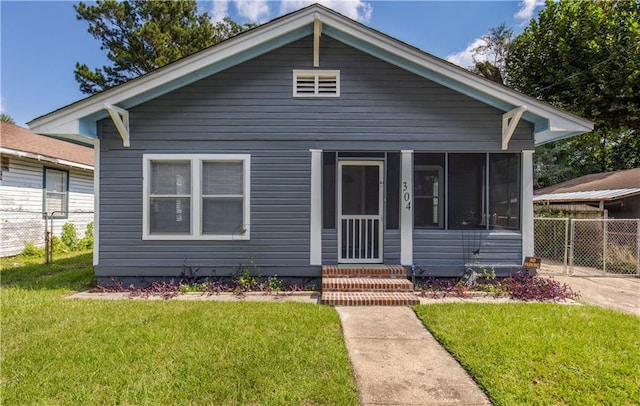 bungalow featuring a front yard and a sunroom