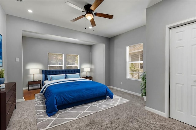 bedroom featuring multiple windows, ceiling fan, and a closet