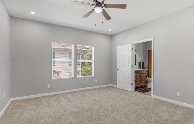 empty room with ceiling fan and light carpet