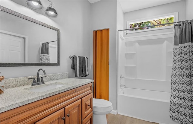 full bathroom with vanity, hardwood / wood-style floors, toilet, and shower / tub combo with curtain