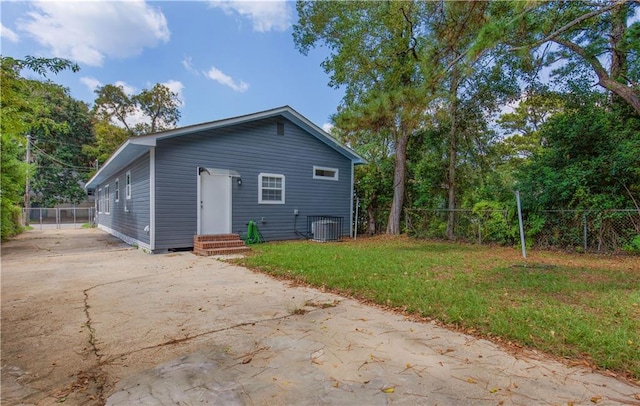 back of property featuring a patio, a yard, and central AC unit