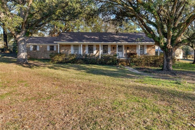 single story home featuring brick siding and a front yard