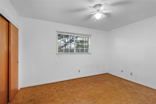 unfurnished bedroom with a ceiling fan, a closet, and baseboards