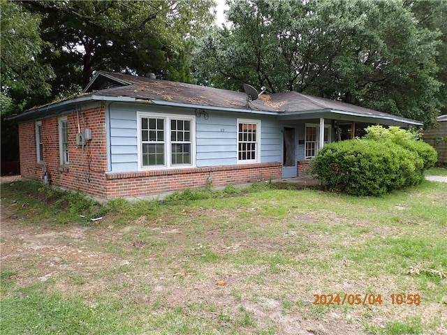 single story home featuring a front lawn