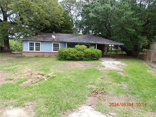 exterior space featuring a yard and a carport