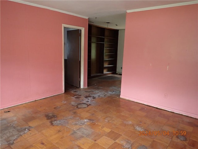 empty room featuring ornamental molding