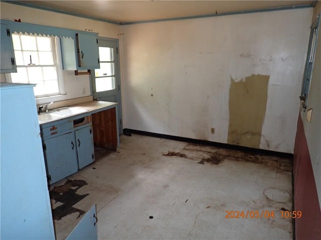 kitchen featuring blue cabinets and sink