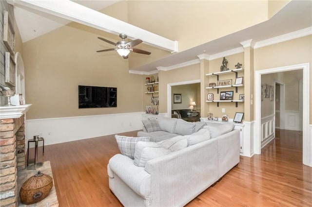 1509 Ridgeland Rd E, Mobile, AL 36695 - living area featuring built in features, a wainscoted wall, light wood-type flooring, ceiling fan, and high vaulted ceiling