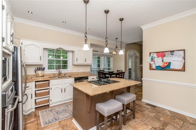1509 Ridgeland Rd E, Mobile, AL 36695 - kitchen with a center island, a kitchen breakfast bar, white cabinets, ornamental molding, and appliances with stainless steel finishes