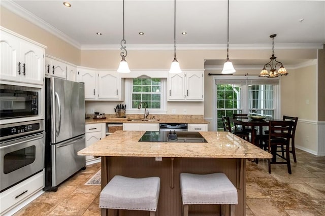 1509 Ridgeland Rd E, Mobile, AL 36695 - kitchen featuring black appliances, plenty of natural light, white cabinets, a chandelier, and crown molding