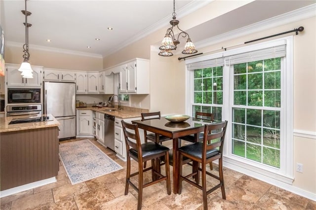 1509 Ridgeland Rd E, Mobile, AL 36695 - dining space featuring ornamental molding, light stone finish floors, and a chandelier