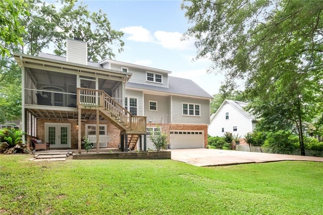 1509 Ridgeland Rd E, Mobile, AL 36695 - rear view of property featuring a sunroom, french doors, brick siding, and an attached garage