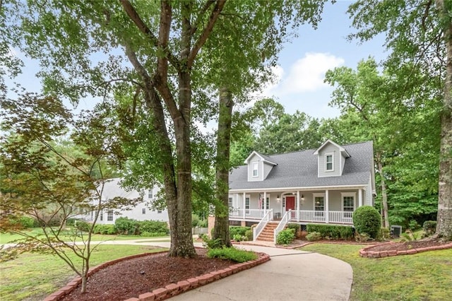 1509 Ridgeland Rd E, Mobile, AL 36695 - cape cod house featuring covered porch, a front lawn, stairs, and driveway