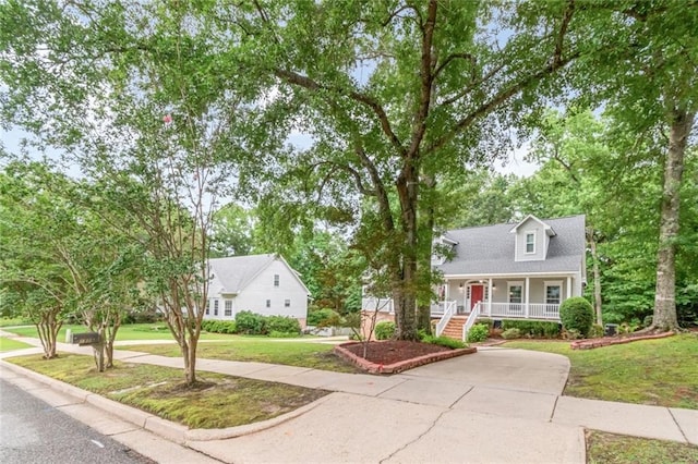 1509 Ridgeland Rd E, Mobile, AL 36695 - cape cod house featuring covered porch, a front yard, stairs, and concrete driveway