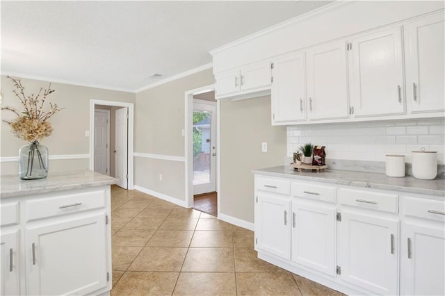 1115 Newbury Ln W, Mobile, AL 36695 - kitchen with backsplash, light tile patterned flooring, white cabinets, and crown molding