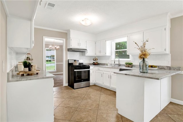 1115 Newbury Ln W, Mobile, AL 36695 - kitchen featuring stainless steel gas stove, under cabinet range hood, a peninsula, decorative backsplash, and white cabinetry