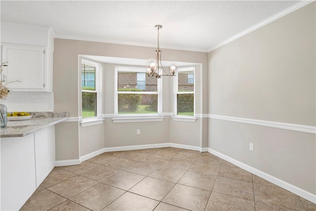 1115 Newbury Ln W, Mobile, AL 36695 - unfurnished dining area featuring a chandelier, a textured ceiling, plenty of natural light, light tile patterned floors, and ornamental molding