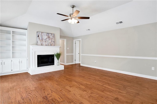 1115 Newbury Ln W, Mobile, AL 36695 - unfurnished living room featuring vaulted ceiling, a ceiling fan, wood finished floors, and a fireplace