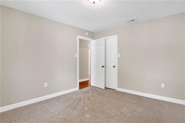 1115 Newbury Ln W, Mobile, AL 36695 - unfurnished bedroom featuring carpet, a textured ceiling, and a closet