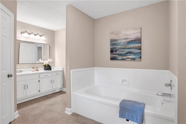 1115 Newbury Ln W, Mobile, AL 36695 - full bath featuring vanity, a bath, a textured ceiling, and tile patterned flooring