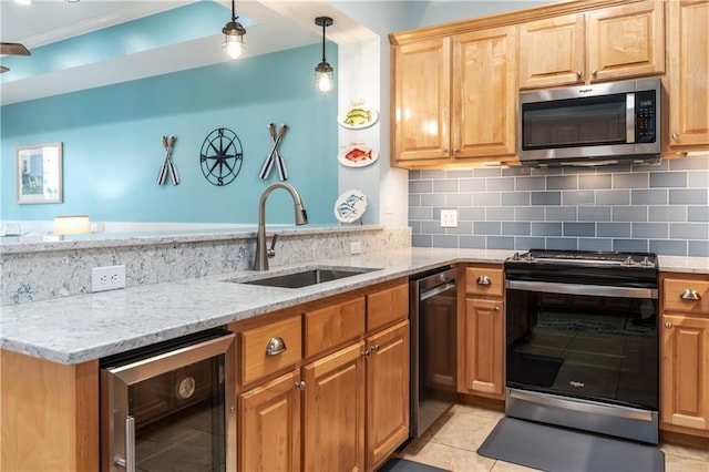 kitchen featuring stainless steel appliances, wine cooler, a sink, and decorative backsplash