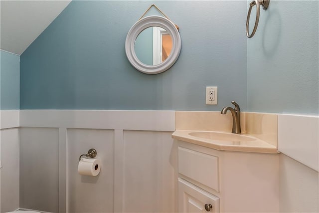 bathroom featuring vaulted ceiling and vanity