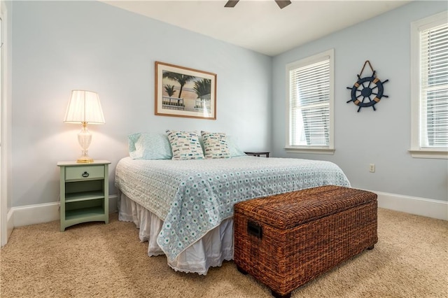 bedroom featuring baseboards, a ceiling fan, and light colored carpet