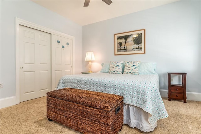 bedroom featuring a ceiling fan, carpet, baseboards, and a closet