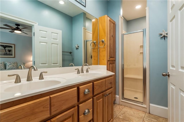 full bathroom featuring double vanity, a sink, a ceiling fan, and a shower stall