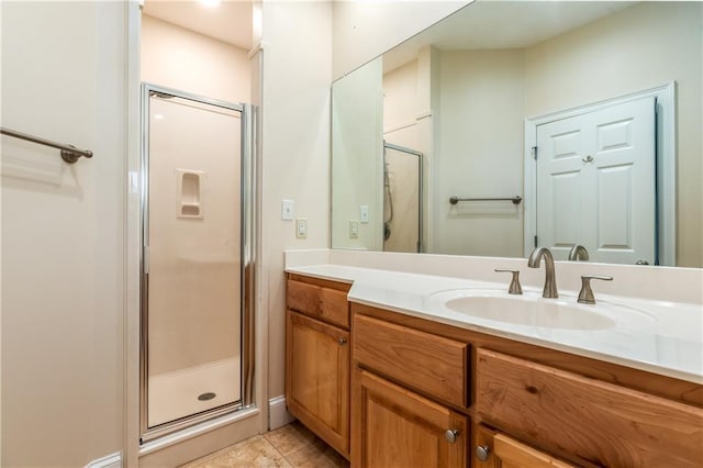 full bath with a stall shower, tile patterned flooring, and vanity