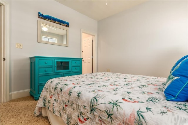 bedroom featuring baseboards and light colored carpet