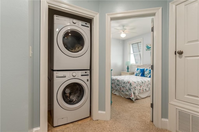 laundry area with ceiling fan, visible vents, and stacked washer / dryer