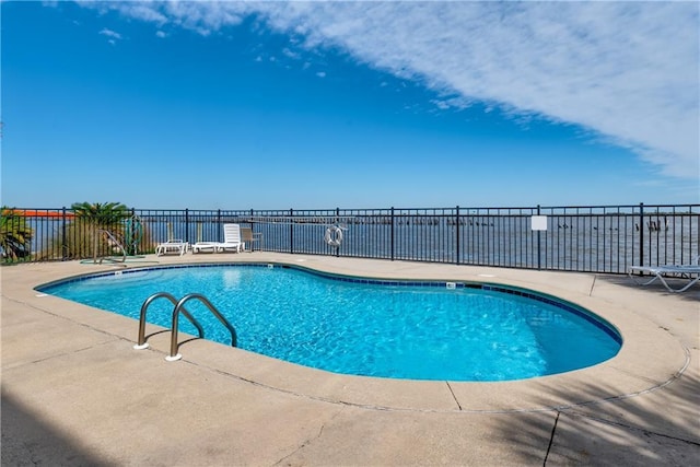 community pool featuring a patio area and fence