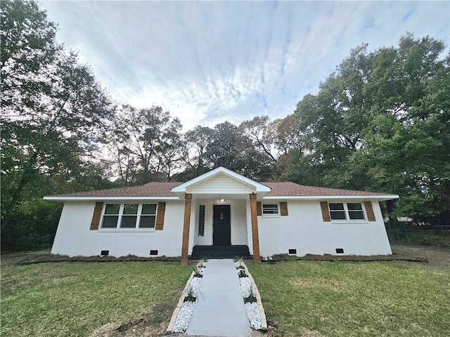 ranch-style home with a front lawn