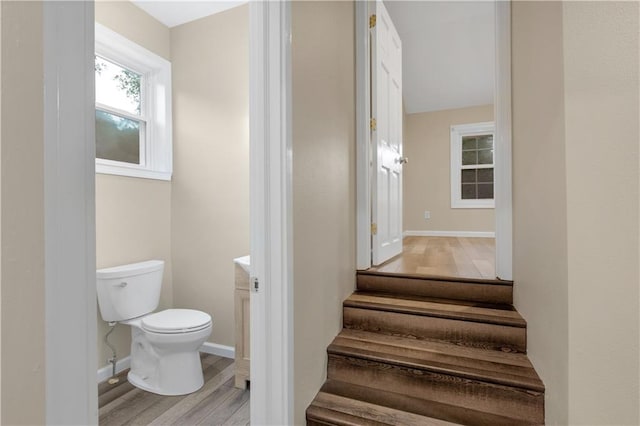 bathroom featuring hardwood / wood-style floors and toilet