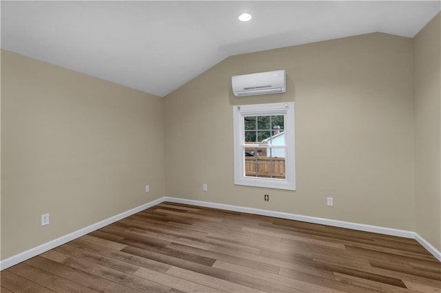 bonus room featuring a wall mounted AC, light hardwood / wood-style floors, and lofted ceiling