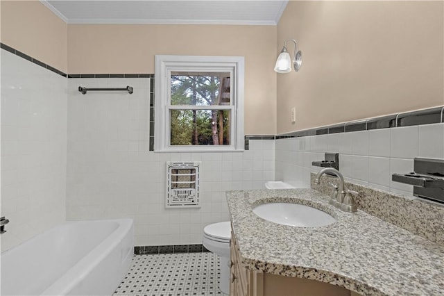 bathroom featuring ornamental molding, heating unit, vanity, toilet, and tile walls