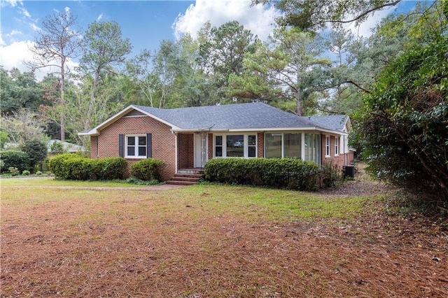 ranch-style home with a front lawn