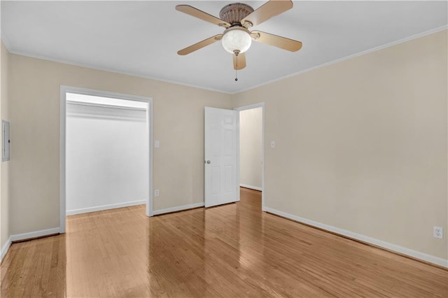 unfurnished bedroom featuring ornamental molding, hardwood / wood-style floors, ceiling fan, and a closet