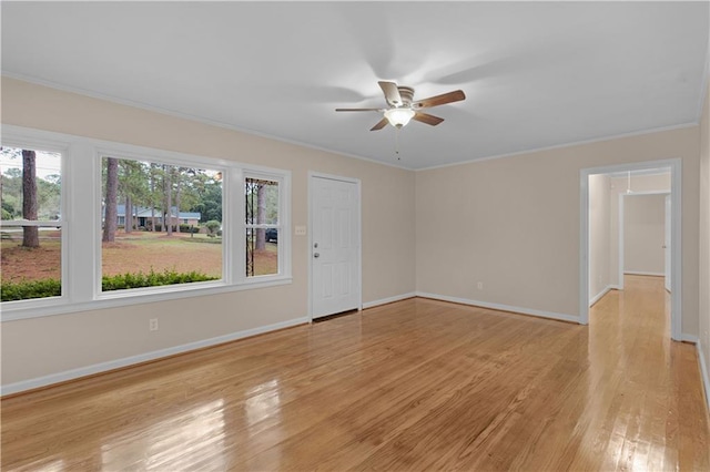 unfurnished room with light hardwood / wood-style floors, ceiling fan, plenty of natural light, and ornamental molding