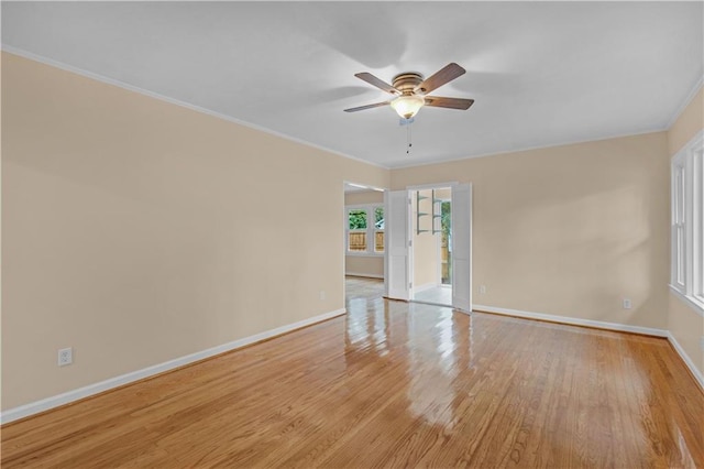 spare room featuring ornamental molding, ceiling fan, and light hardwood / wood-style floors