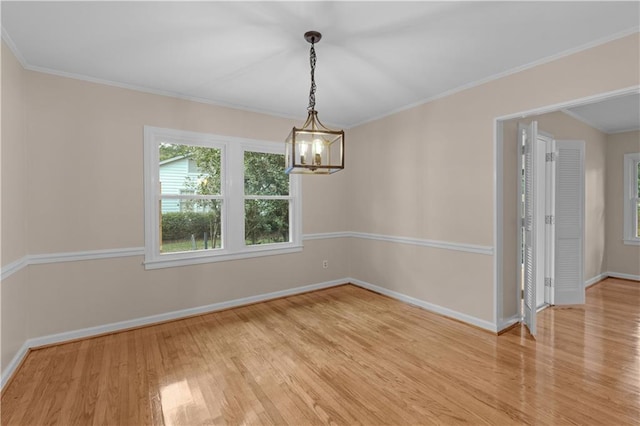 424 Byron Ave E, Mobile, AL 36609 - empty room with light wood finished floors, baseboards, a chandelier, and ornamental molding
